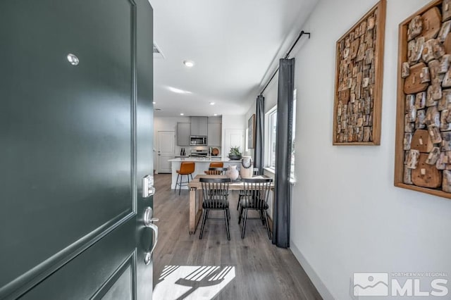 corridor featuring recessed lighting, light wood finished floors, and visible vents
