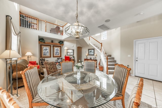 tiled dining space featuring an inviting chandelier, stairway, and visible vents