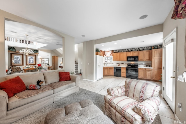 living area with stairs, light tile patterned floors, baseboards, a notable chandelier, and recessed lighting
