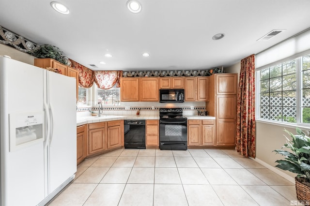 kitchen with visible vents, recessed lighting, tile countertops, a sink, and black appliances