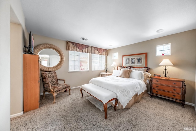 carpeted bedroom with visible vents and baseboards