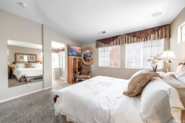bedroom with baseboards, vaulted ceiling, ensuite bathroom, and carpet