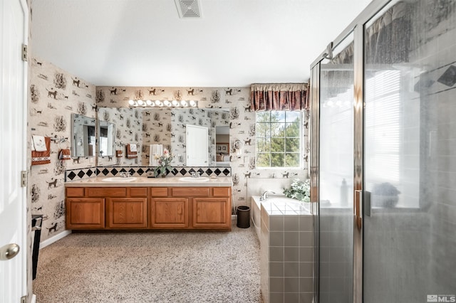 bathroom with double vanity, a garden tub, visible vents, a shower stall, and wallpapered walls