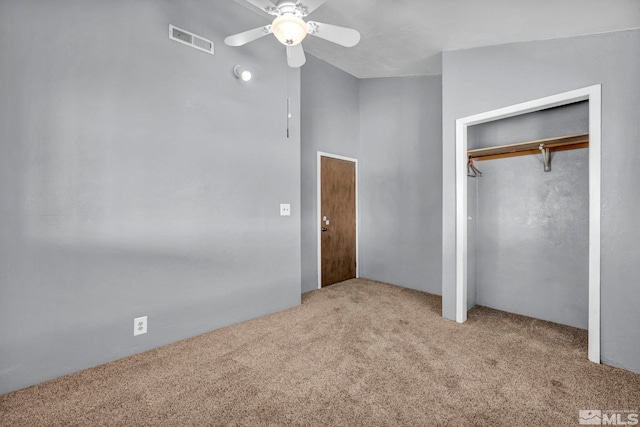 unfurnished bedroom with carpet flooring, a ceiling fan, and visible vents