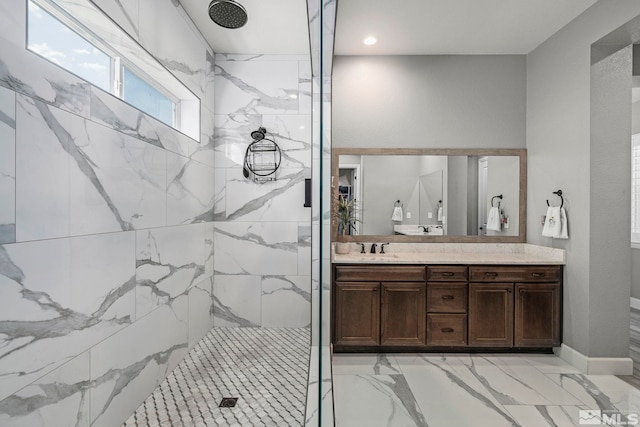 bathroom featuring a marble finish shower, vanity, and marble finish floor
