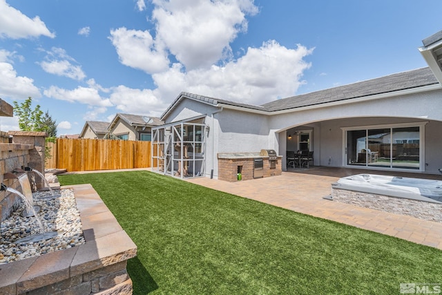 view of yard with a fenced backyard, a patio, and exterior kitchen
