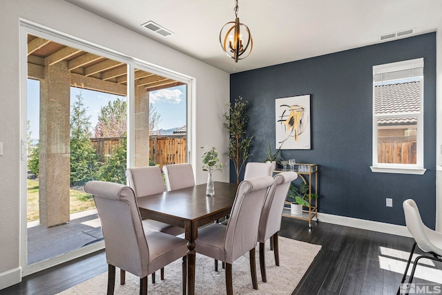 dining space with baseboards, dark wood-style floors, and visible vents