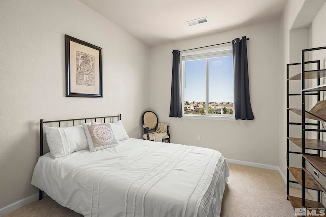 carpeted bedroom featuring baseboards and visible vents