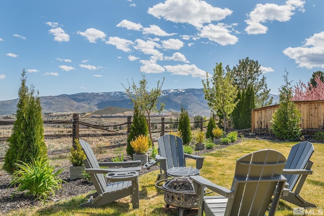 view of yard with fence and a mountain view