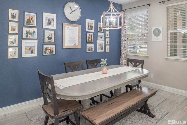 dining room featuring baseboards and wood finished floors