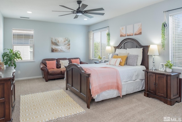 bedroom featuring multiple windows, light carpet, and visible vents