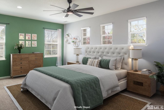 carpeted bedroom with a ceiling fan, baseboards, recessed lighting, and multiple windows