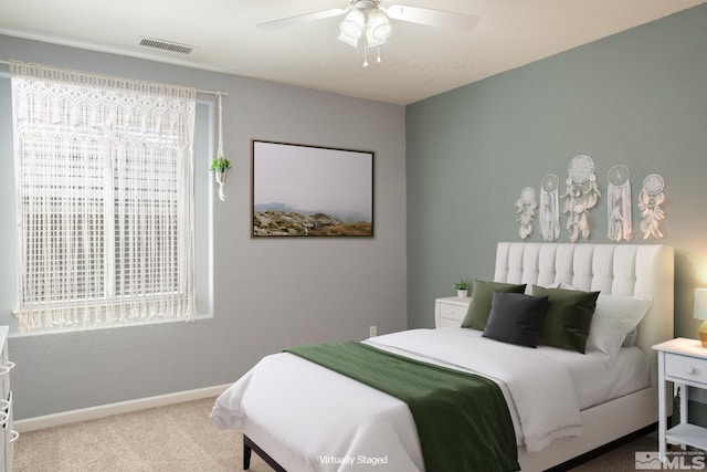 bedroom with baseboards, carpet flooring, visible vents, and multiple windows