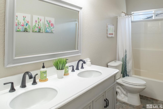 bathroom featuring double vanity, a sink, shower / bath combination with curtain, and toilet