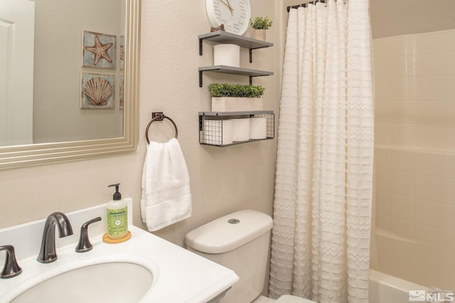 full bath featuring a sink, shower / tub combo, and toilet