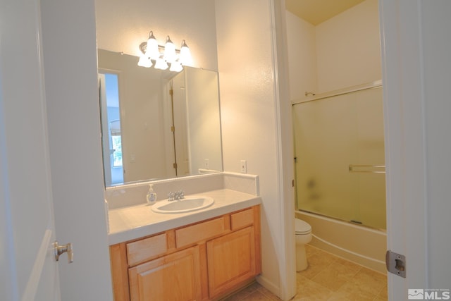full bathroom featuring vanity, enclosed tub / shower combo, tile patterned floors, and toilet