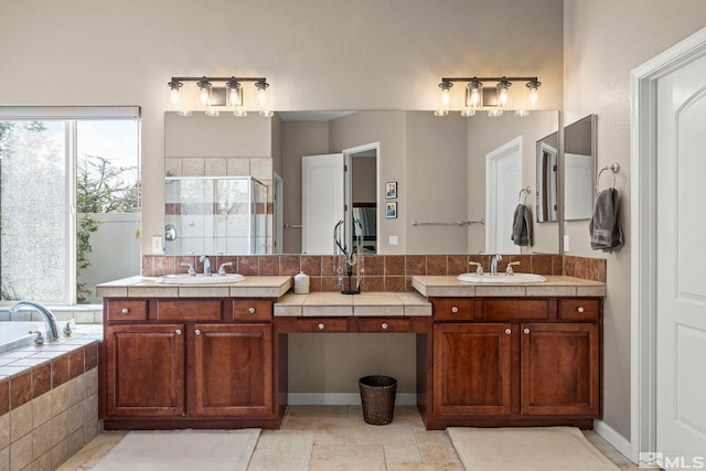 full bath with a shower stall, a healthy amount of sunlight, and vanity