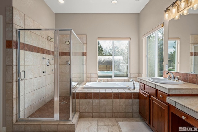 full bathroom featuring a garden tub, recessed lighting, vanity, and a shower stall