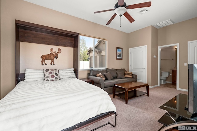 bedroom with ceiling fan, visible vents, carpet, and ensuite bath