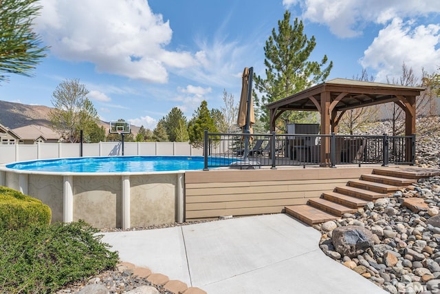 view of swimming pool featuring fence, a gazebo, and a fenced in pool