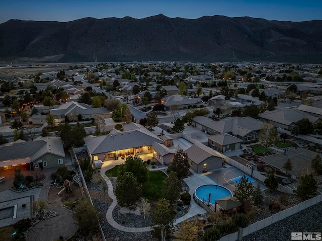 drone / aerial view featuring a residential view and a mountain view