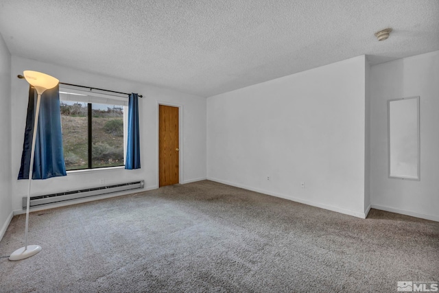 carpeted empty room with baseboards, baseboard heating, and a textured ceiling