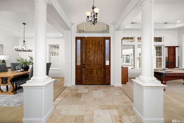 foyer with baseboards, decorative columns, and a notable chandelier