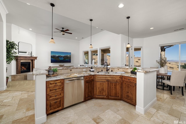 kitchen with ceiling fan, dishwasher, a sink, stone tile flooring, and recessed lighting