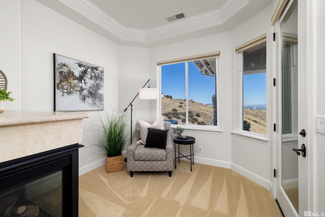 sitting room featuring carpet flooring, crown molding, a raised ceiling, baseboards, and visible vents