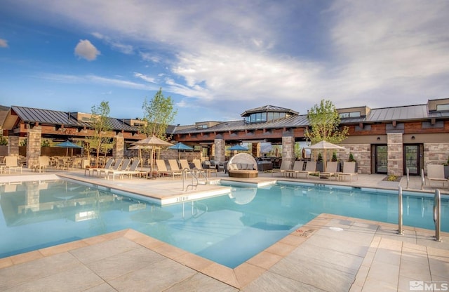 community pool featuring a patio area