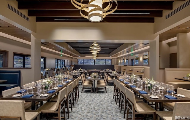dining space with beamed ceiling and visible vents