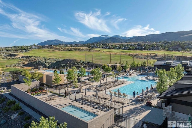 community pool with a mountain view