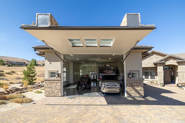 view of front of home featuring stucco siding and stone siding