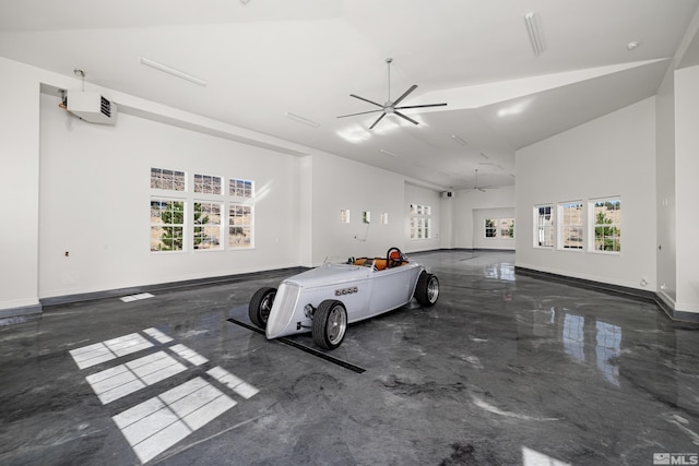 garage featuring ceiling fan and baseboards