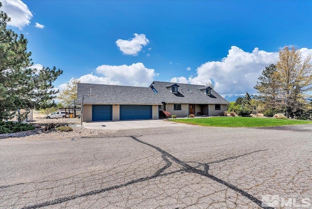 view of property with a shingled roof, a front lawn, aphalt driveway, a garage, and stucco siding