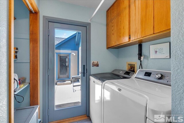 laundry area with cabinet space and independent washer and dryer