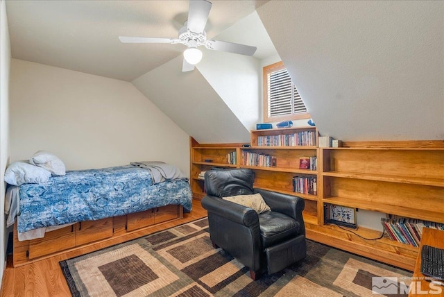 bedroom featuring vaulted ceiling and wood finished floors