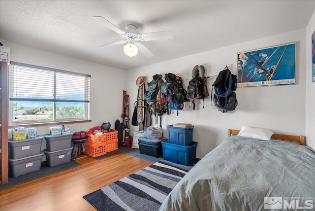 bedroom with ceiling fan and wood finished floors