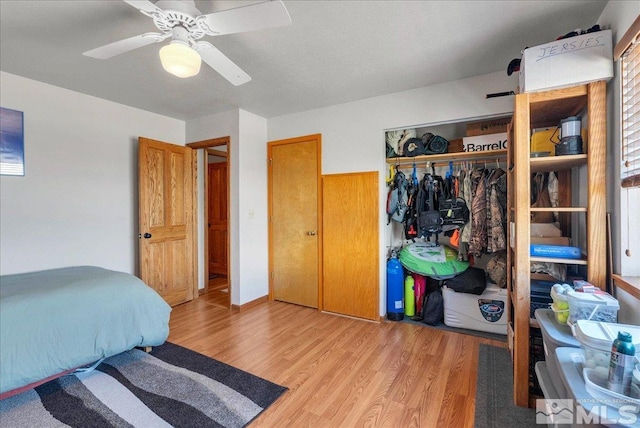 bedroom with a ceiling fan, a closet, and light wood finished floors