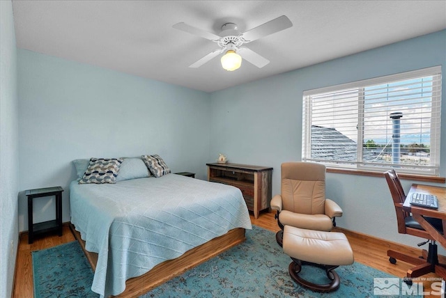 bedroom with ceiling fan and wood finished floors