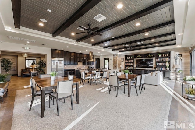 dining area featuring visible vents, ceiling fan, wooden ceiling, and beamed ceiling