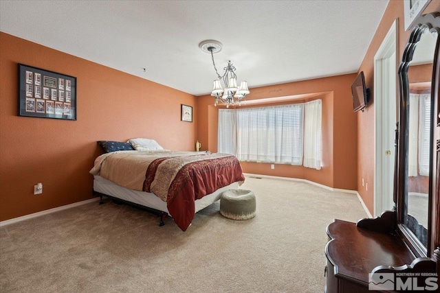 bedroom featuring baseboards, carpet flooring, and a chandelier