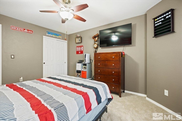 bedroom featuring light colored carpet, baseboards, and ceiling fan