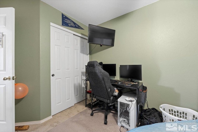 carpeted office with lofted ceiling