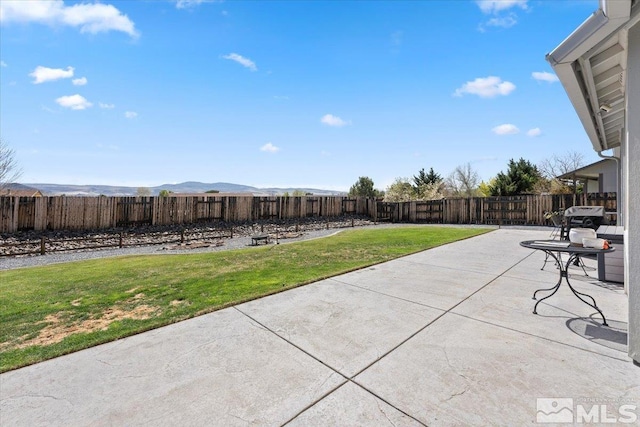 view of patio featuring a fenced backyard and a mountain view