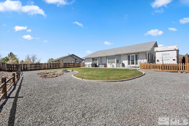 back of house featuring a fenced front yard and a yard