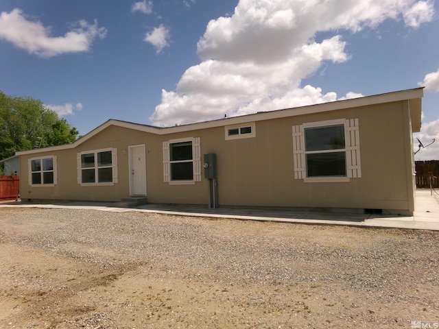 rear view of property featuring fence