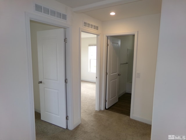 corridor featuring recessed lighting, baseboards, visible vents, and carpet