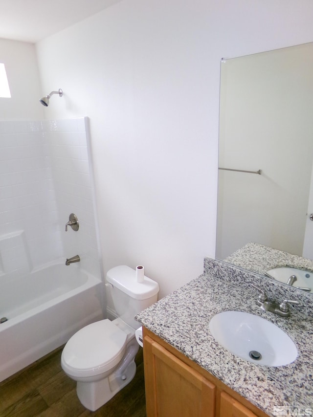 bathroom featuring tub / shower combination, wood finished floors, toilet, and vanity
