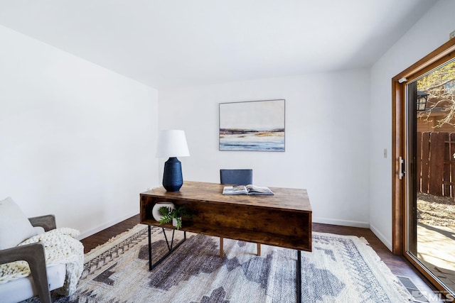 home office with baseboards, visible vents, and wood finished floors